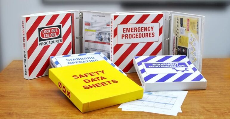 On a table, binders of safety data sheets are organized for easy access to important safety information.